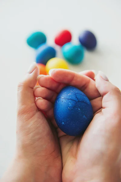 eggs. Easter. Easter eggs. colored eggs. Eggs on a white background. Eggshell. The girl cleans an egg. Girl\'s hands