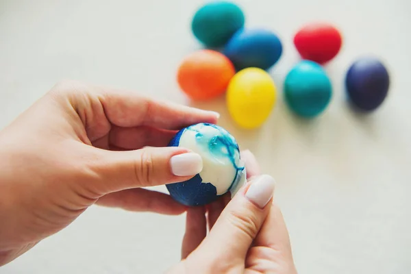 eggs. Easter. Easter eggs. colored eggs. Eggs on a white background. Eggshell. The girl cleans an egg. Girl's hands