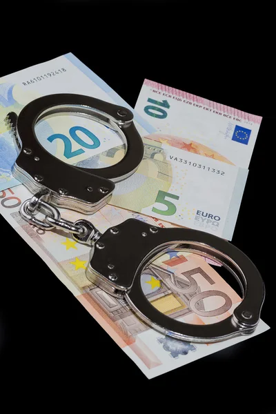 Handcuffs and money — Stock Photo, Image