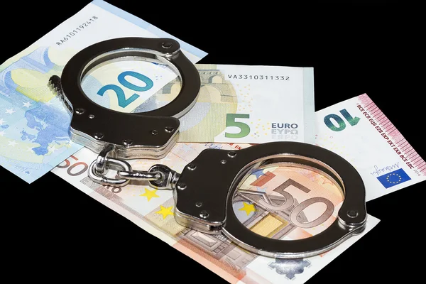 Handcuffs and money — Stock Photo, Image