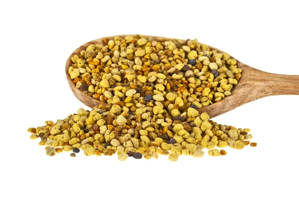 Pile of bee pollen in wooden spoon on a white background — Stock Photo, Image