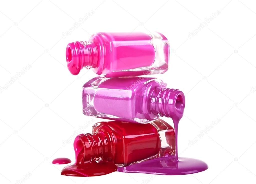 Bottles with spilled nail polish on a white background