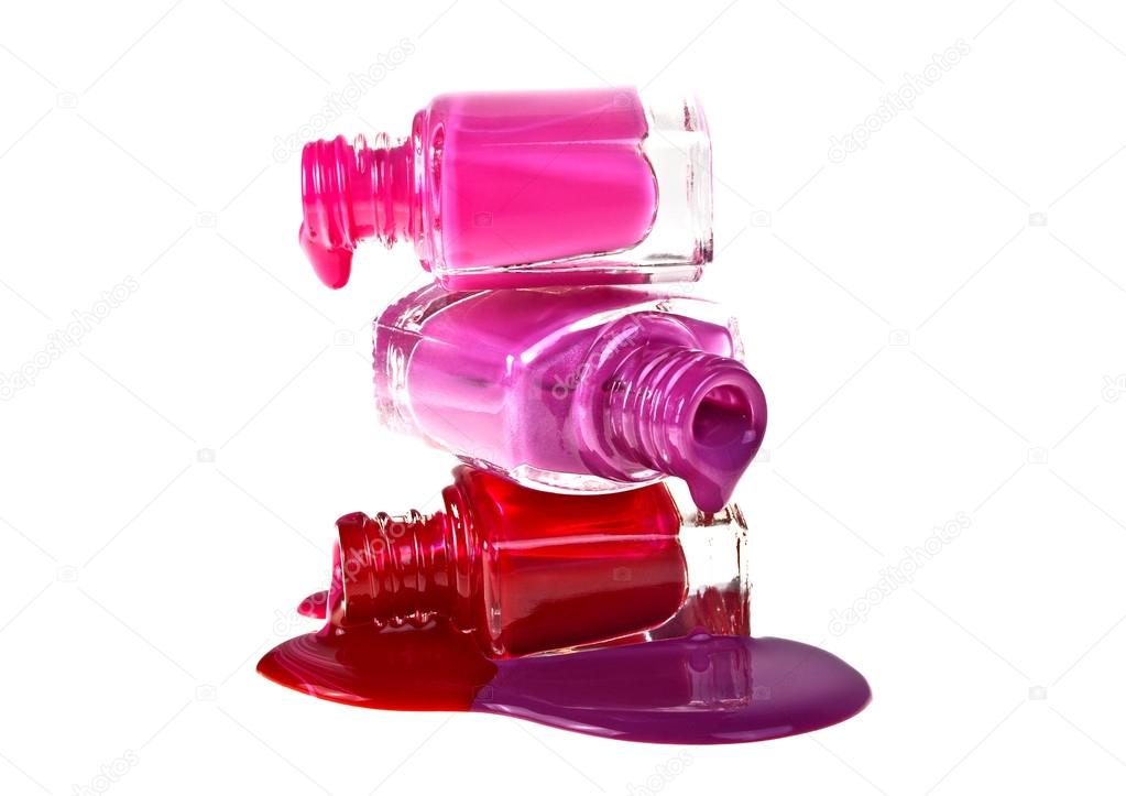 Bottles with spilled nail polish on a white background