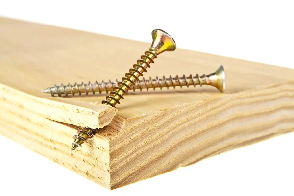 Tornillos dorados atornillados en tablón de madera —  Fotos de Stock