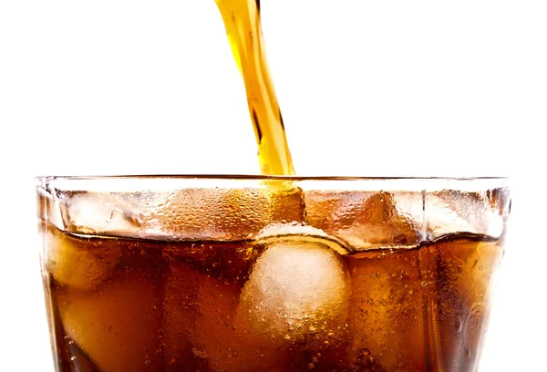 Pouring cola drink to glass with ice, on a white background — Stock Photo, Image