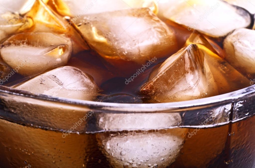 Background of cola with ice cubes and bubbles