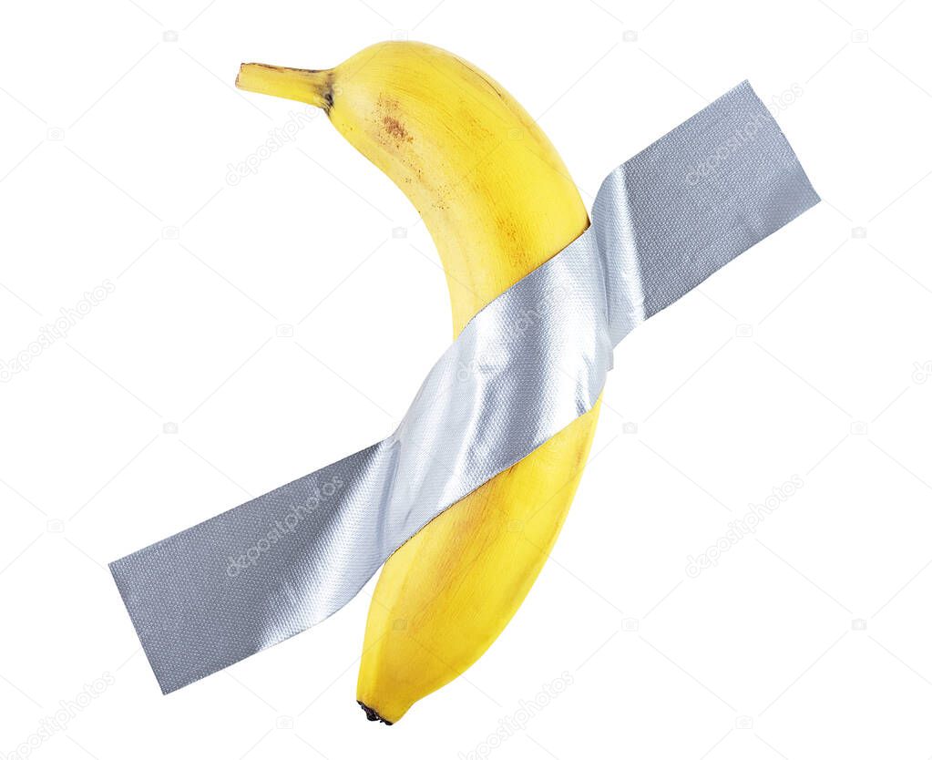Yellow sweet banana on the wall. Banana duct taped to the white wall.