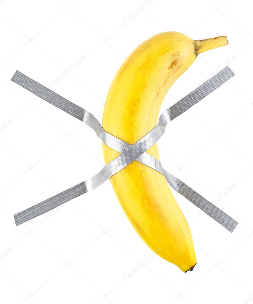 Banana duct taped to the white wall. Yellow sweet banana on the wall.