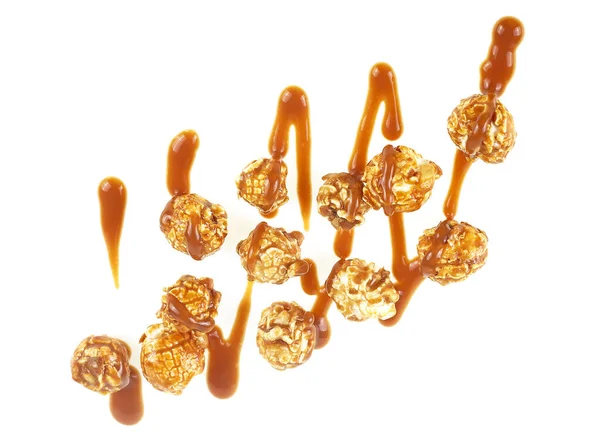 Popcorn with caramel sauce isolated on a white background, top view. Tasty caramel popcorn.