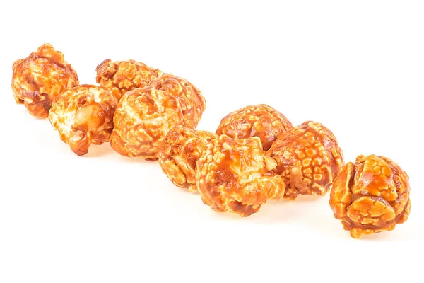 Sweet caramel popcorn isolated on a white background. Pile of cream caramel popcorn.