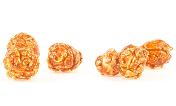 Delicious caramel popcorn isolated on a white background. Sweet caramel candy popcorn pieces.