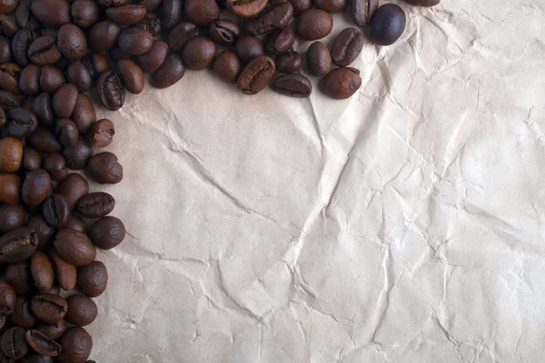 Coffee beans on a paper — Stock Photo, Image