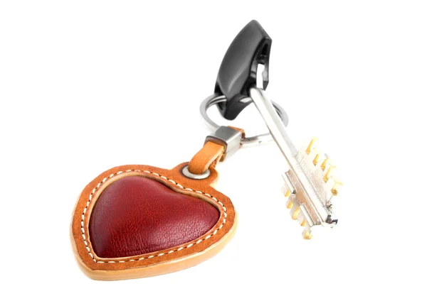 Red leather heart with a key on a white background — Stock Photo, Image