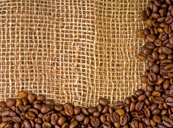 Coffee beans on burlap background — Stock Photo, Image