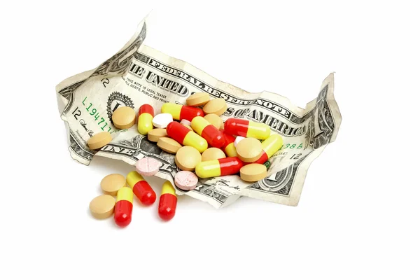 Χρήματα με χάπια που απομονώνονται σε λευκό φόντο — Φωτογραφία Αρχείου