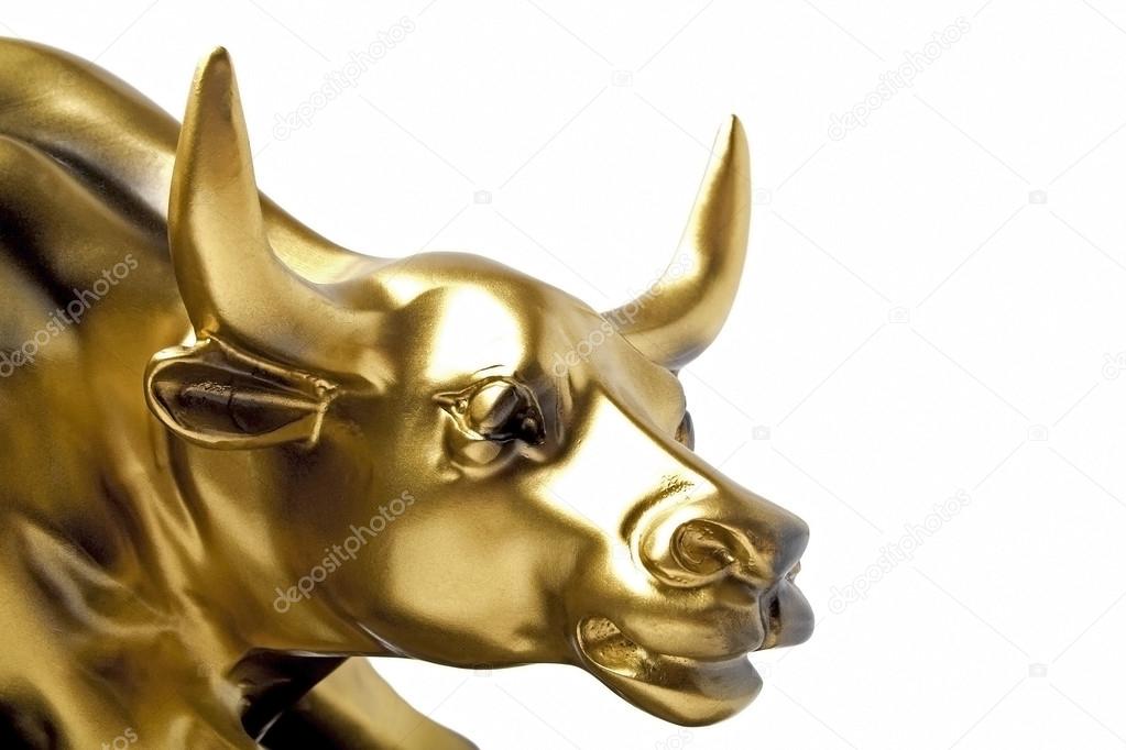 Bull - a gold statue close-up on a white background