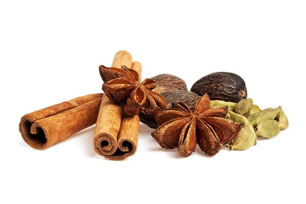Anise, cardamom, nutmeg and cinnamon sticks on a white backgroun — Stock Photo, Image