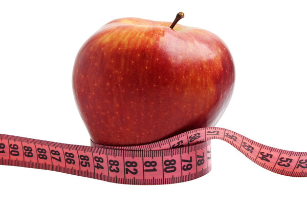 Diet concept - red apple and measuring tape