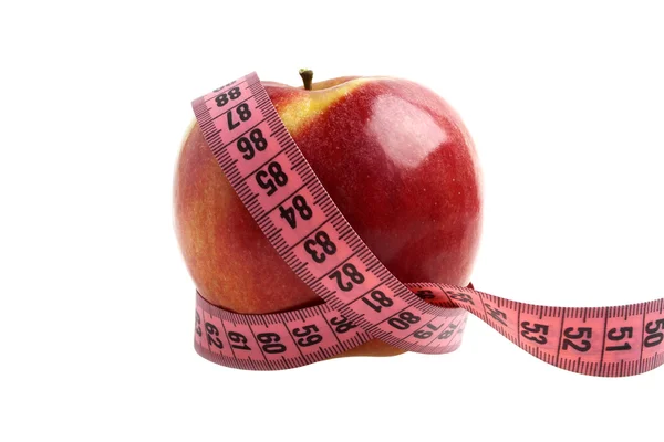 Diet concept - red apple and measuring tape Stock Picture