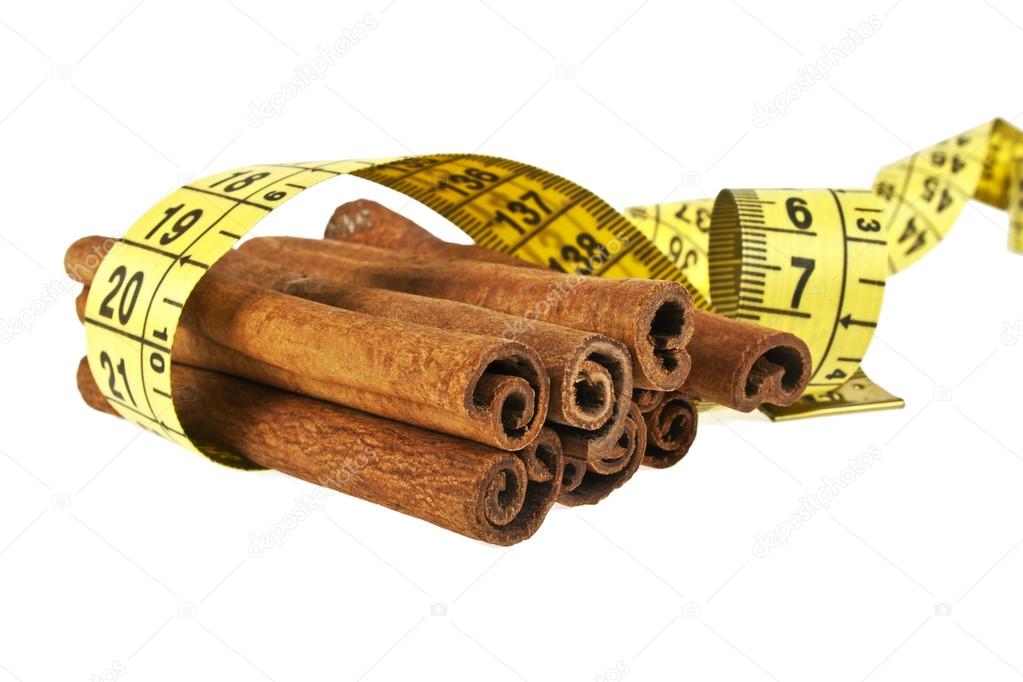 Cinnamon sticks wrapped roulette on a white background