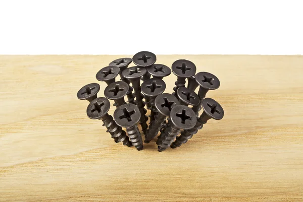 Screws screwed into wooden plank — Stock Photo, Image