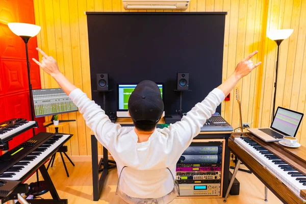 Back Asian Male Music Producer Showing Rock Hand Gesture While — Stock Photo, Image