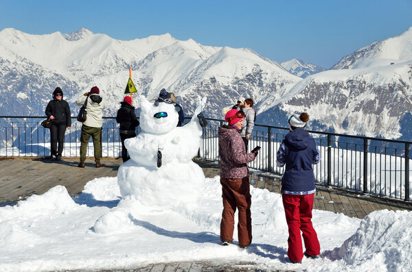 Sochi, Russia, February, 27, 2016, Ski resort Rosa Khutor. People look at of mountains from the observation deck of Rosa peak