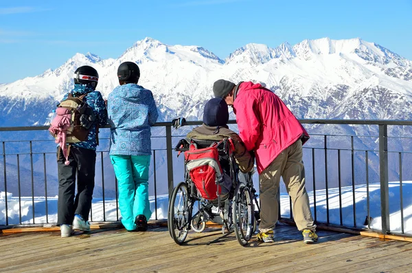 Sochi, Russia, February, 29, 2016, Ski resort Rosa Khutor. Man disabled in wheelchair look for the mountains from the observation deck of Rosa peak — Stock Photo, Image