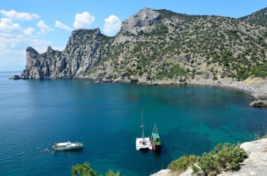Crimea. Novy Svet. Mountain Karaul-Oba and small boats in the blue Bay clipart