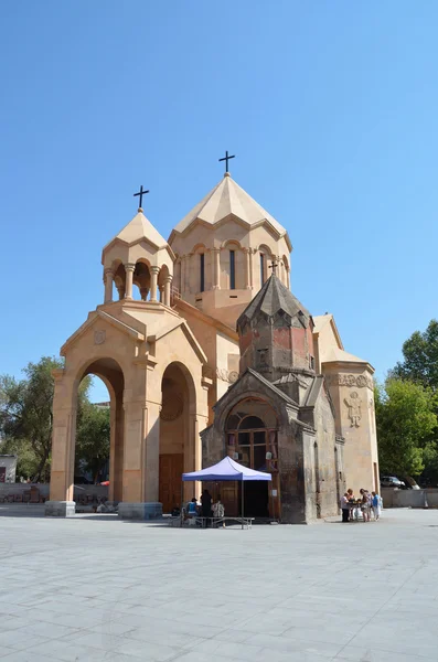 Yerevan, Armenia, September, 15, 2014. People walking near the Church of the Holy Catholike in Yerevan, 13th century, on the background of construction of the residence of the Catholicos of Armenia — 图库照片