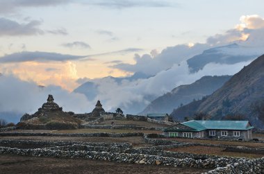 Nepal, the village of Phortse Tenga in the Himalayas, 3600 meters above sea level,  ancient stupas at sunset clipart