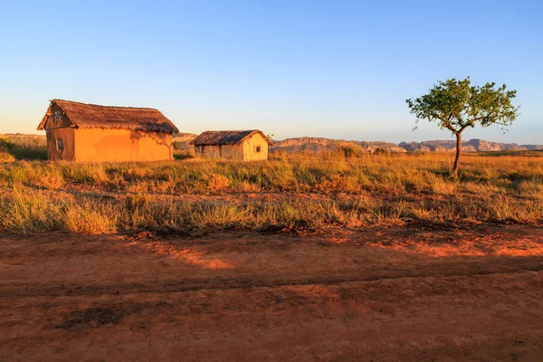 Village in an African landscape at sunrise — Stock Photo, Image
