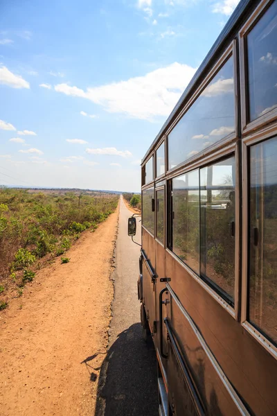 Tourist bus on a desolated road in africa — Stock Photo, Image