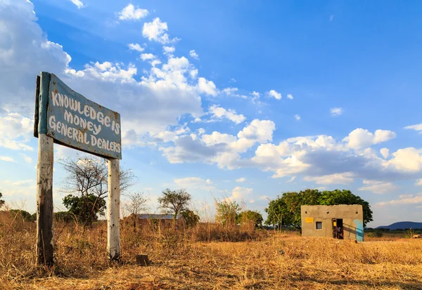 Road sign along the road in African village — Stock Photo, Image