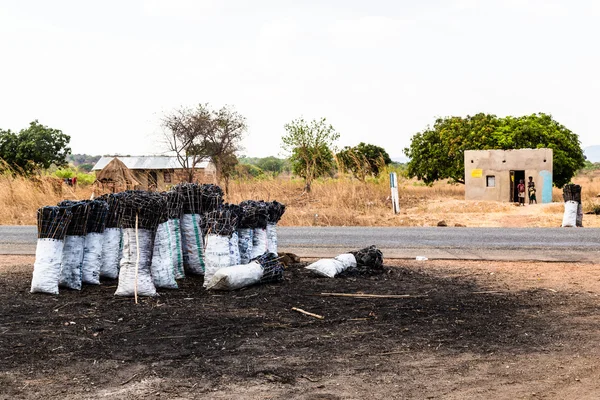 Bag of charcoal along the road in africa — Stock Photo, Image