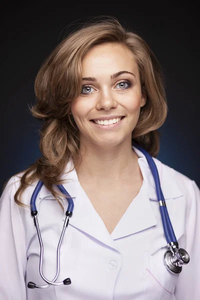 Studio portrait of beautiful woman doctor smiling. — Stock Photo, Image