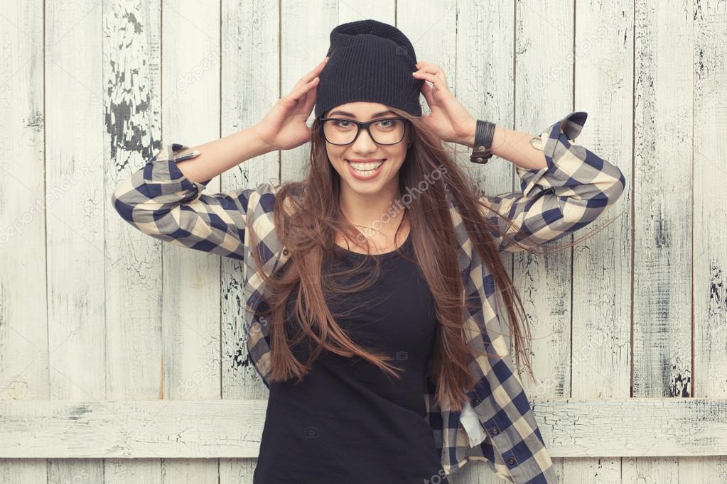 Hipster girl in glasses and black beanie Stock Photo by ©doodko 70192653