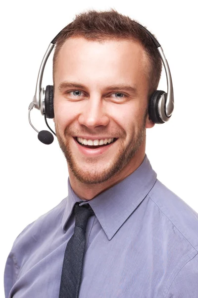 Guapo sonriente joven hombre de negocios usando auriculares —  Fotos de Stock