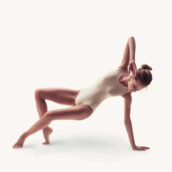 Young beautiful dancer in beige swimsuit — Stock Photo, Image