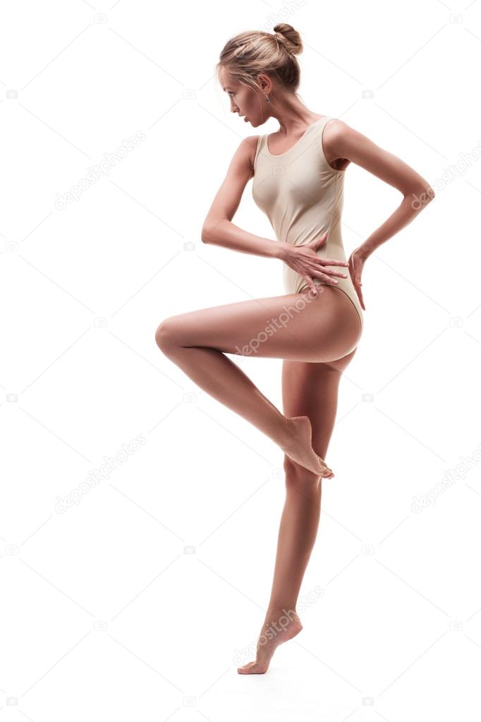 young beautiful dancer in beige swimsuit 