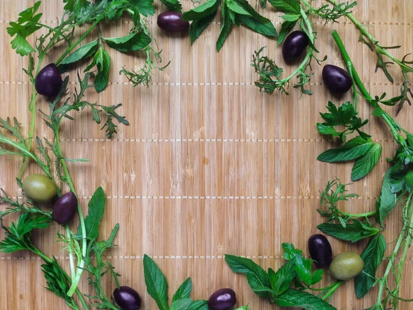 Herbs and spices in a round frame on bamboo background. Top view