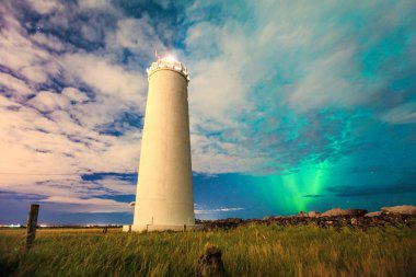 Aurora borealis at the lighthouse clipart