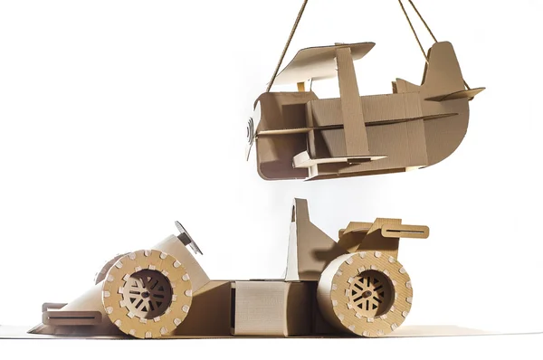 Cardboard racing car and cardboard plane — Stock Photo, Image