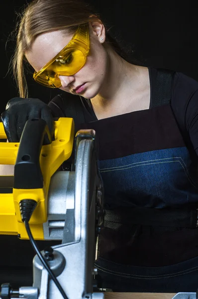 Woman with a circular disk saw — Stock Photo, Image