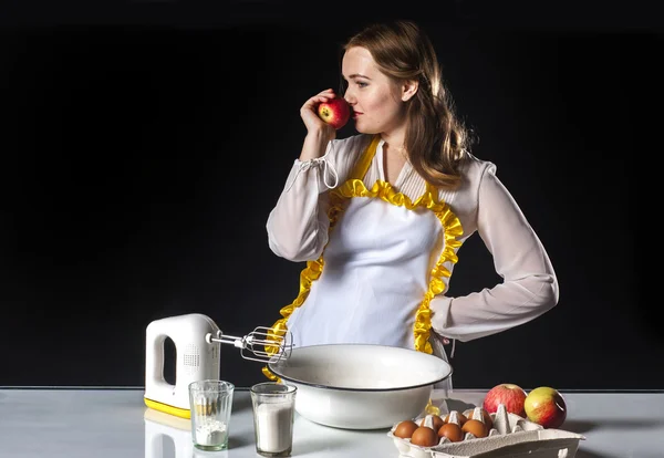 Smiling homemaker sniffing apple — Stock Photo, Image