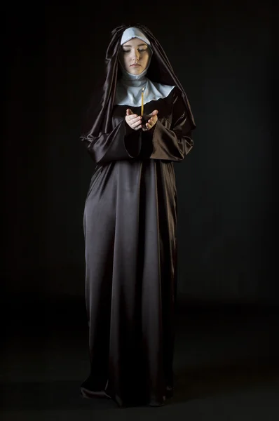 Nun holding candle — Stock Photo, Image