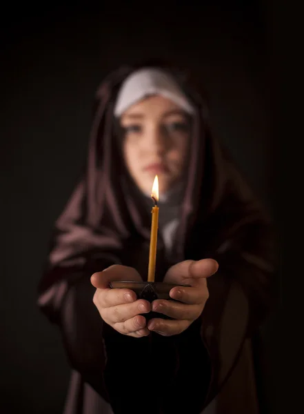 Nun with candle. — Stock Photo, Image