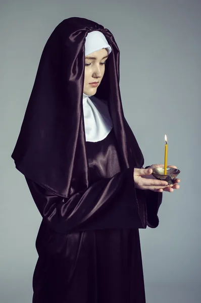 Nun with candle. — Stock Photo, Image