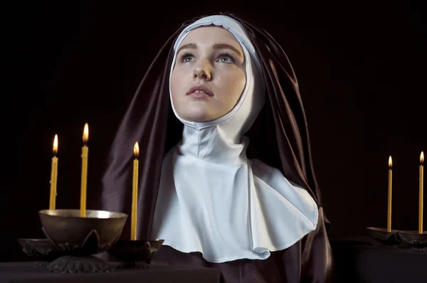 Nun with candles. — Stock Photo, Image