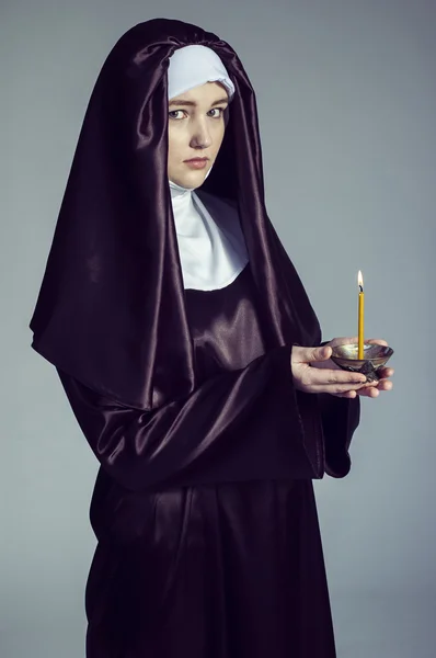 Nun with candle. — Stock Photo, Image